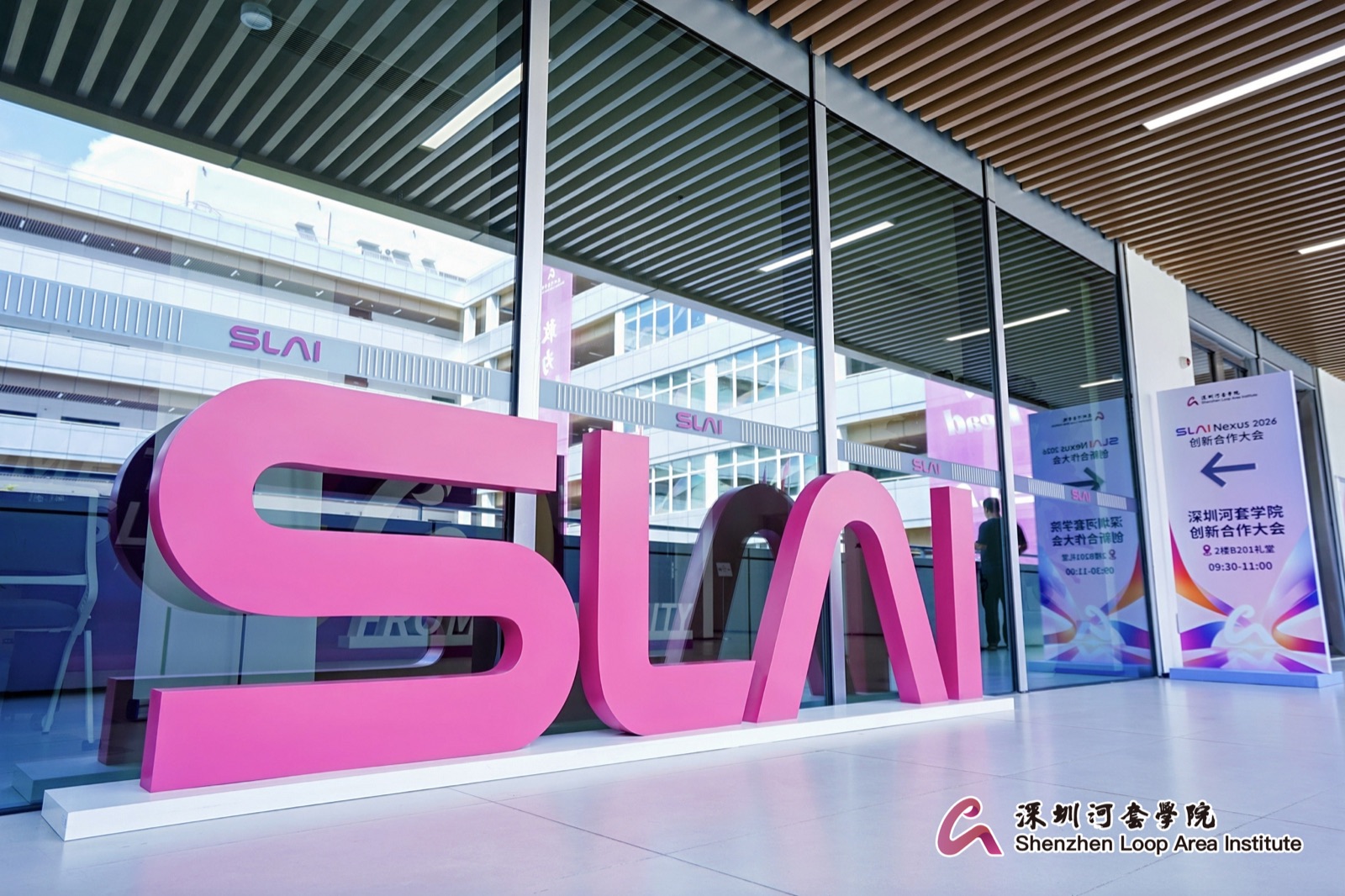 Large magenta SLAI letters in the institute lobby
