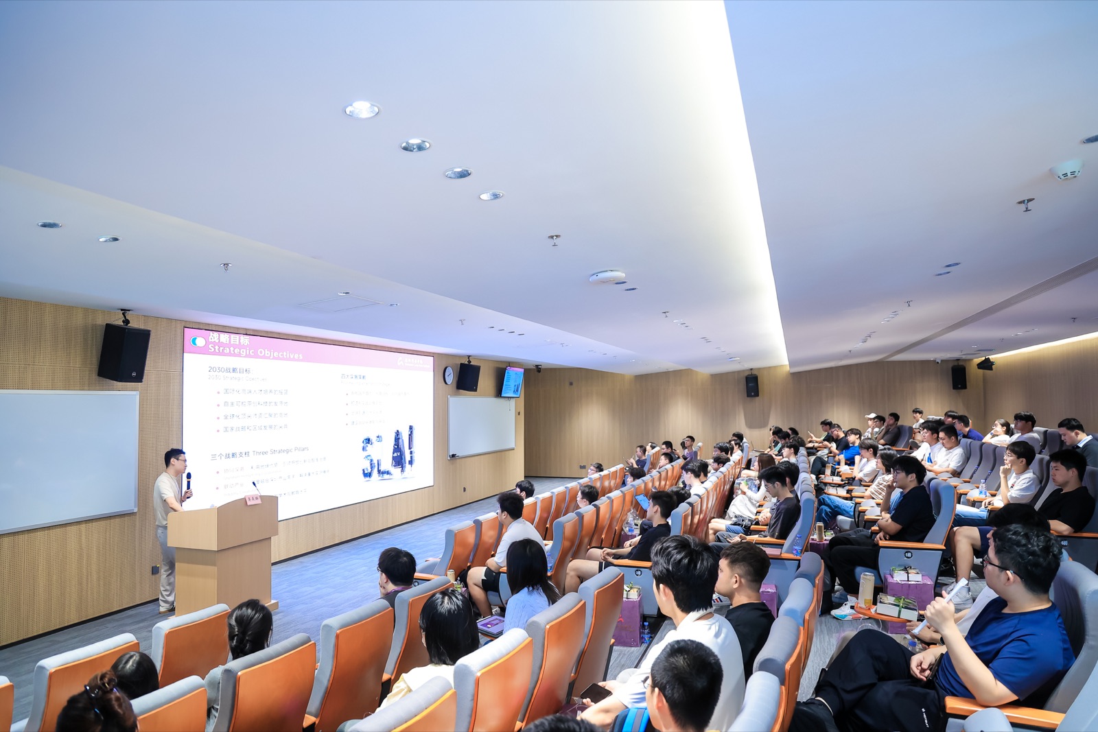 A speaker presenting to students in an SLAI lecture theatre