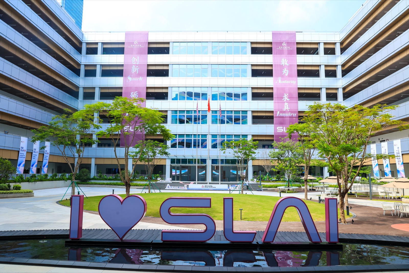 SLAI campus courtyard with the I love SLAI installation